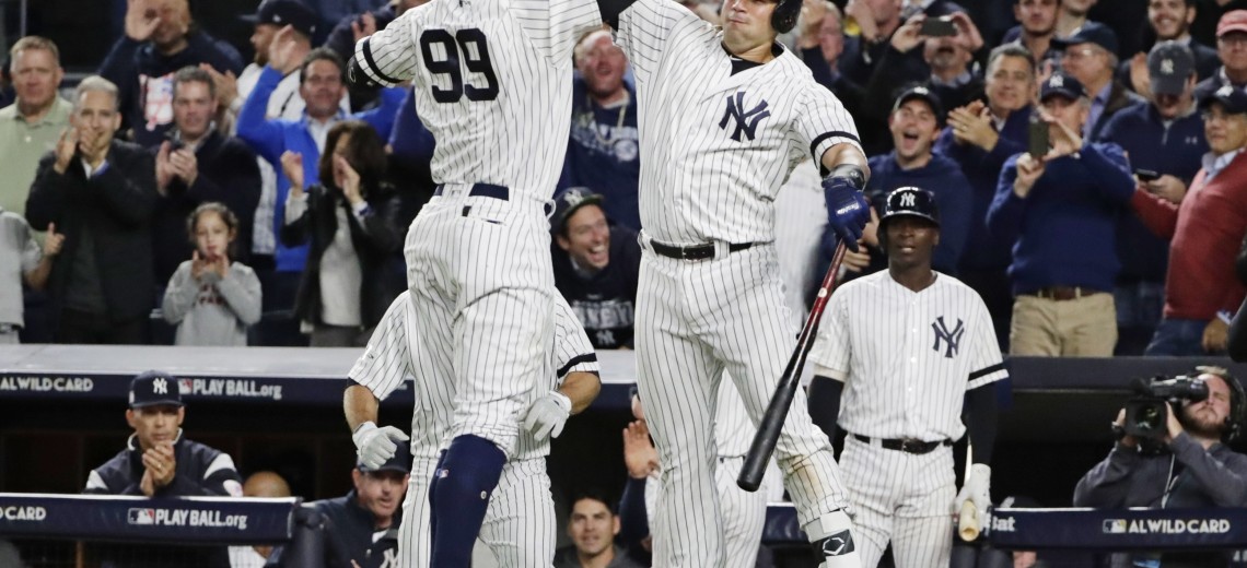 New York Yankees' Aaron Judge (99) celebrates with Gary Sanchez after hitting a two-run home run during the fourth inning of the American League wild-card baseball game against the Minnesota Twins on Tuesday, Oct. 3, 2017, in New York. (AP Photo/Frank Franklin II)