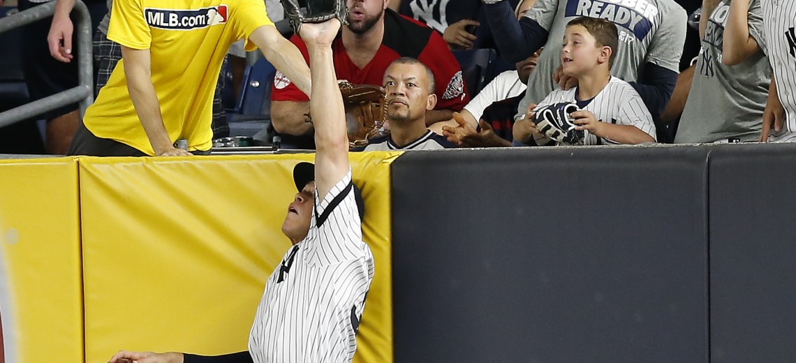 New York Yankees right fielder Aaron Judge makes a catch at the wall on a line drive hit by Cleveland Indians' Francisco Lindor during the sixth inning in Game 3 of baseball's American League Division Series, Sunday, Oct. 8, 2017, in New York. (AP Photo/Kathy Willens)
