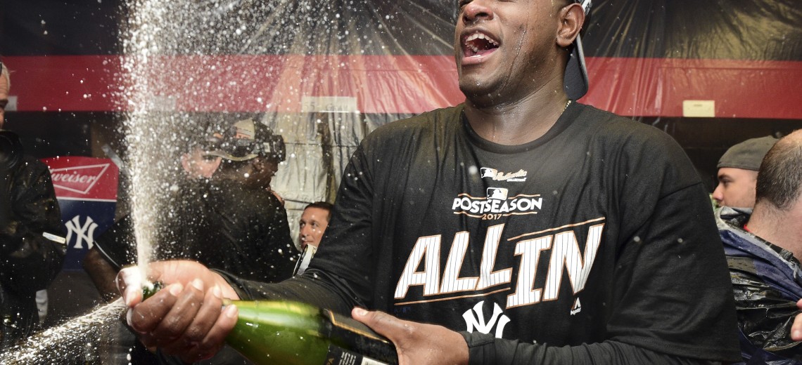 New York Yankees starting pitcher Luis Severino sprays sparkling wine in the locker room the Yankees defeated the Cleveland Indians 5-2 in Game 5 of a baseball American League Division Series, early Thursday, Oct. 12, 2017, in Cleveland. The Yankees advanced to the ALCS. (AP Photo/David Dermer)